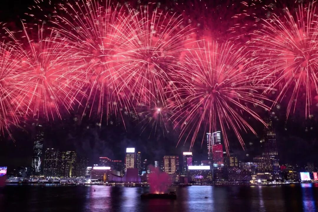 Red fireworks illuminate the Hong Kong skyline